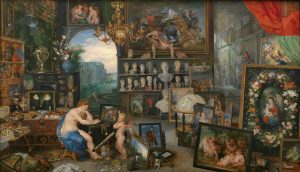A painting of a woman and winged boy in a large room filled with paintings, statues, and other assorted objects, almost identical to the painting in the exhibition. This is the original, painted by Jan Brueghel the Elder and Peter Paul Rubens.